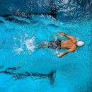 Person Swimming on Body of Water